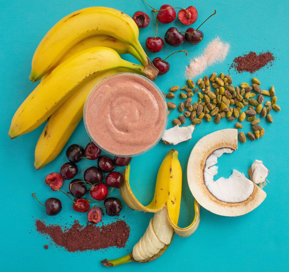 smoothie with fruit and nuts on blue counter