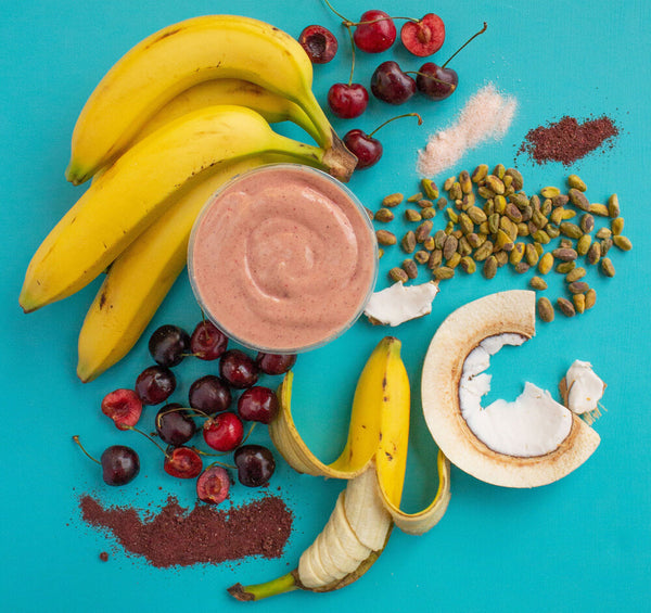 smoothie with fruit and nuts on blue counter
